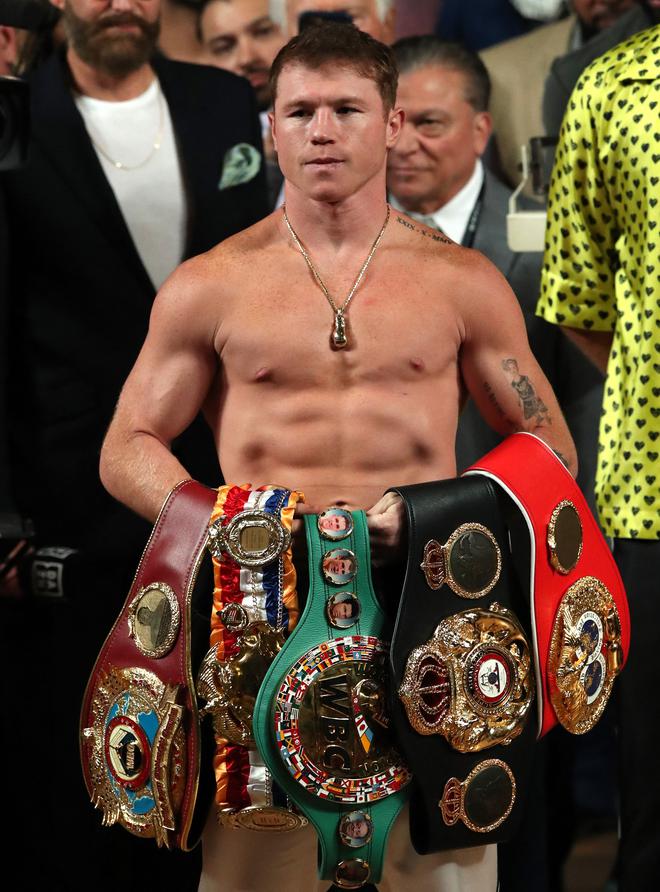 
Canelo Alvarez poses with his belts at the weigh-in.