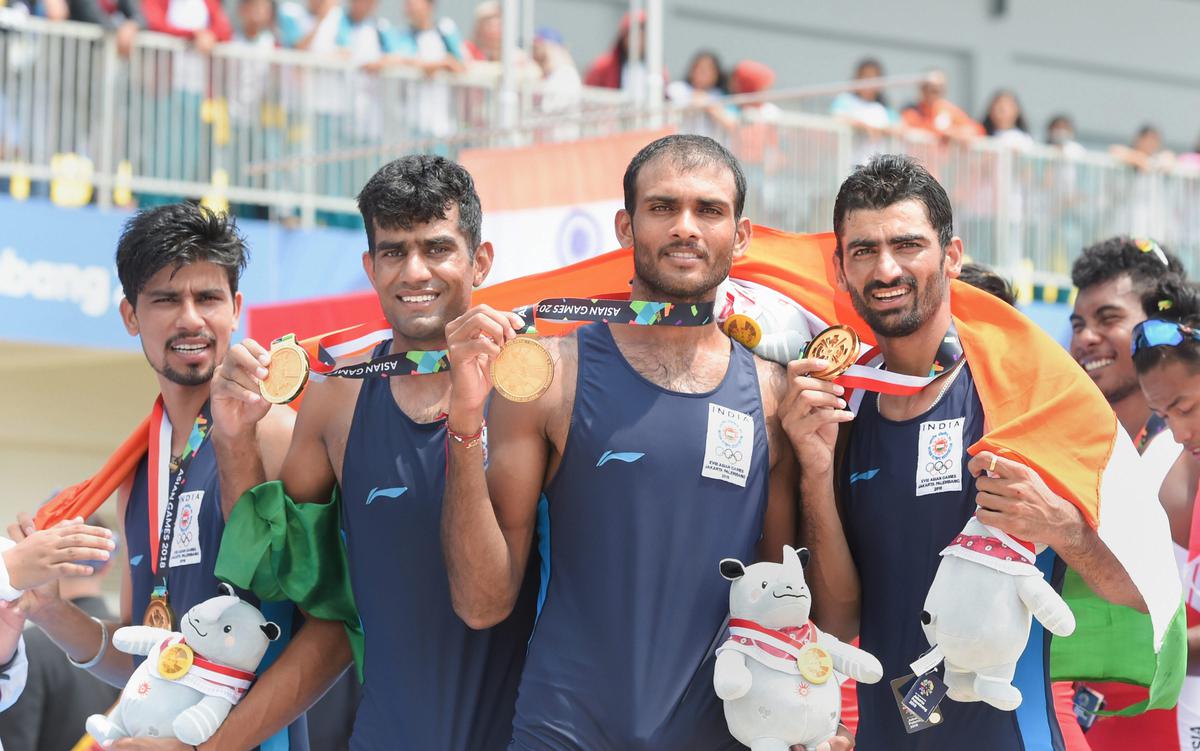 Gold medallists in Indian rowing: Men’s team members Sawarn Singh, Bhokanal Dattu, Om Prakash, and S Singh pose for a photo after the medal ceremony for the Men’s Quadruple Sculls event at the 18th Asian Games.