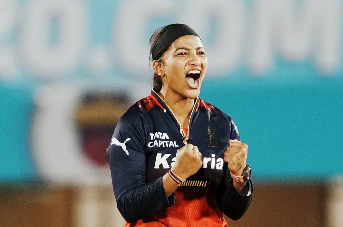 Royal Challengers Bengaluru’s Sneh Rana celebrates the wicket of Mumbai Indians’ Hayley Matthews during the Women’s Premier League (WPL) 2025 cricket match.