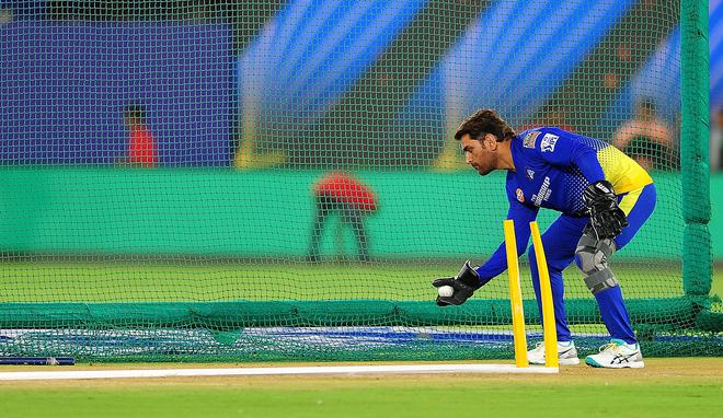 A rare sight: Dhoni was sharpening his wicketkeeping and opted against a net batting session on Friday.
