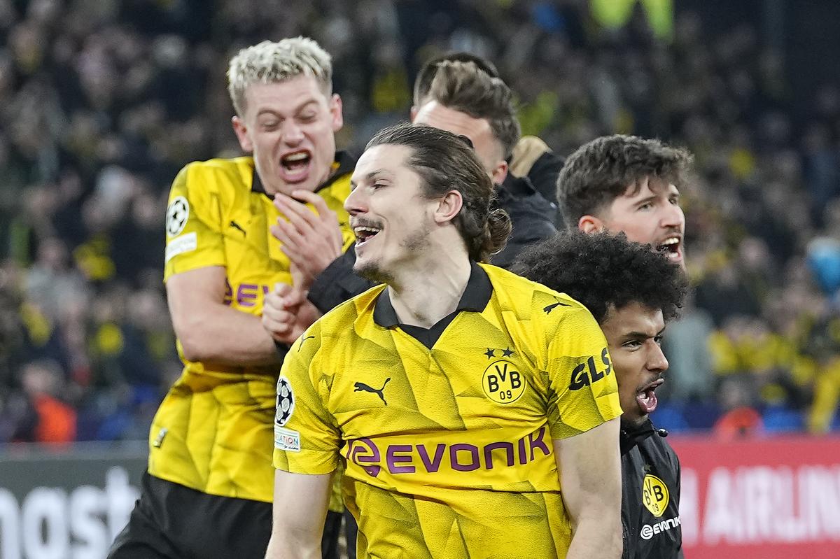 Marcel Sabitzer, in front, celebrates with his team after winning the Champions League quarterfinal second leg match between Borussia Dortmund and Atletico Madrid at the Signal-Iduna Park in Dortmund, Germany, Tuesday, April 16, 2024.