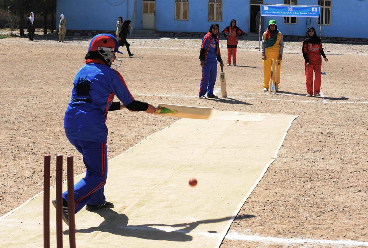 Afghan girls play cricket on the school grounds in Herat on September 2, 2013. 