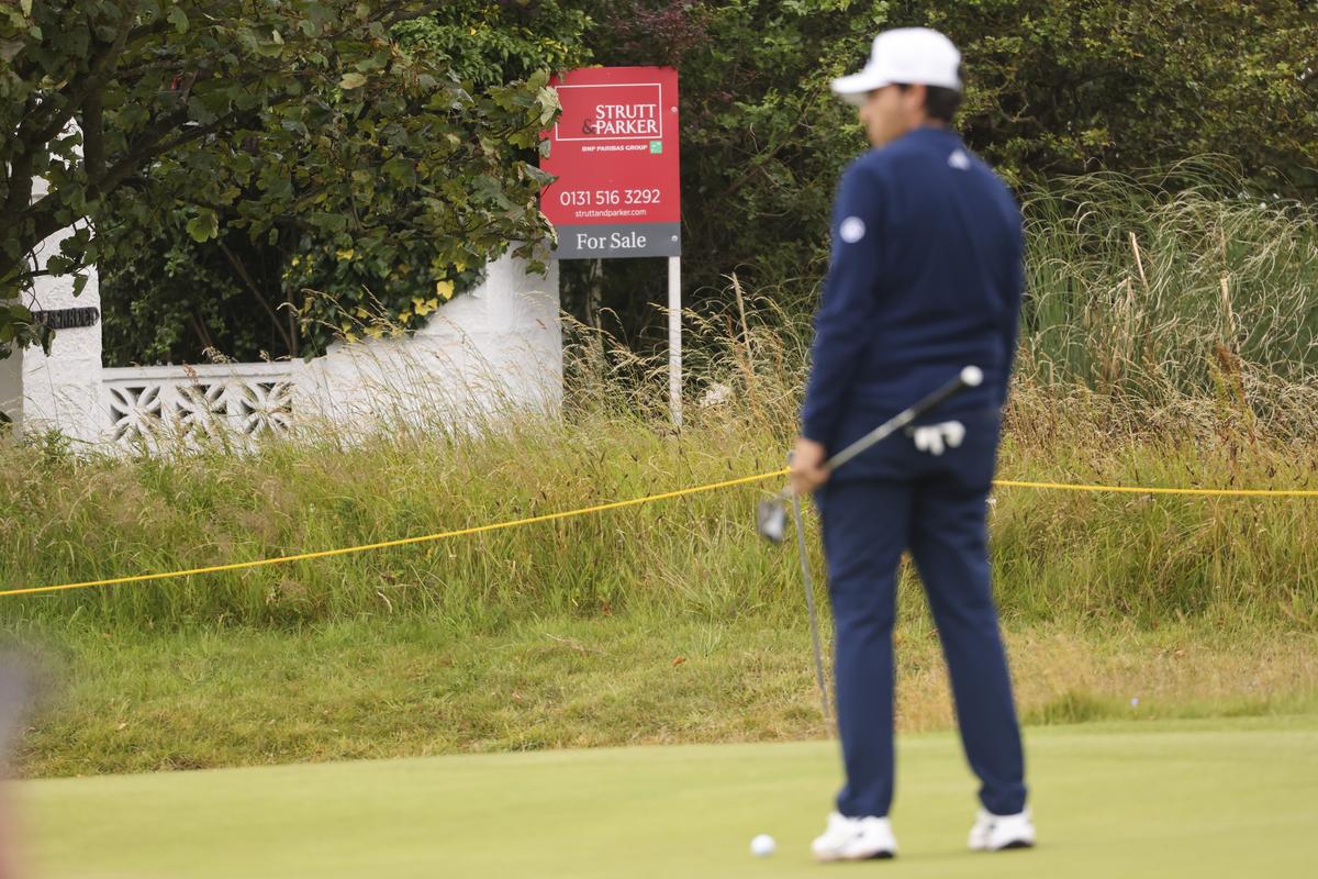 A golfer waits to putt on the 17th green, near “Blackrock house” that is listed for sale near the second and 16th holes at Royal Troon golf club, venue for the British Open Golf Championships, in Troon, Scotland, on Tuesday.