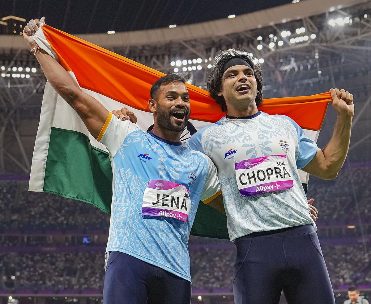 Dynamic duo: Neeraj Chopra and Kishore Jena wave the national flag after securing gold and silver medals, respectively, in the men’s javelin throw final event at the 19th Asian Games in Hangzhou, China, in 2023.