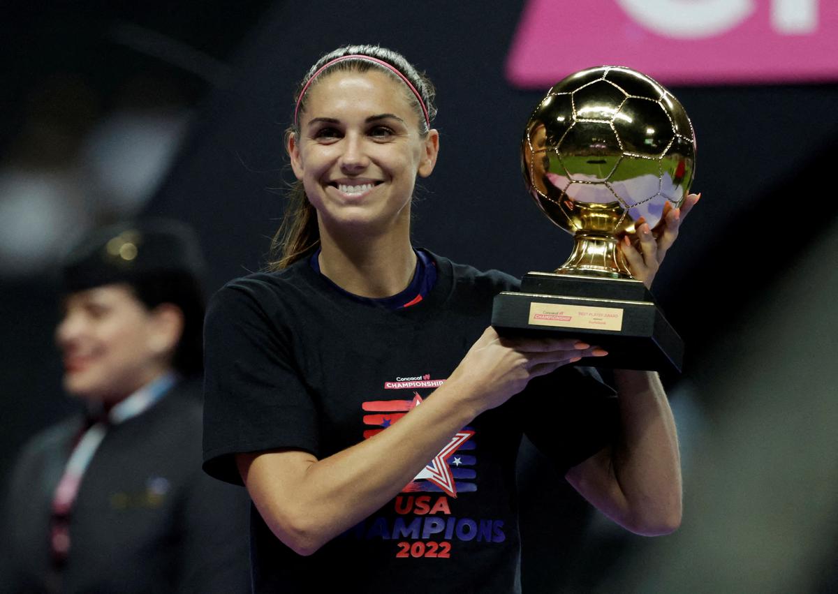 FILE PHOTO: Alex Morgan of the U.S. poses with the best player trophy after the Concacaf Women’s Championship final against Canada. 