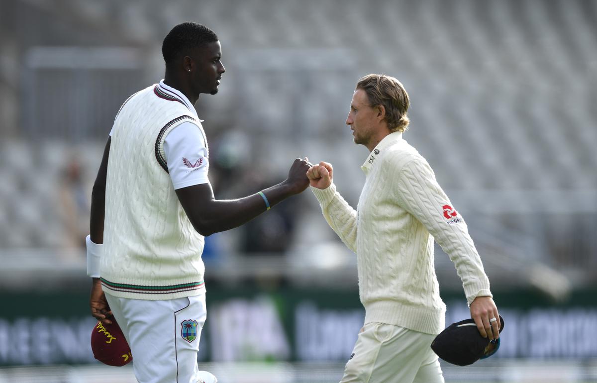 FILE PHOTO: Joe Root of England with Jason Holder of West Indies after victory on Day Five of the 2nd Test Match in the series between England and The West Indies at Emirates Old Trafford.