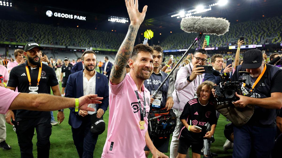 Lionel Messi of Inter Miami CF poses with his t-shirt during a news News  Photo - Getty Images