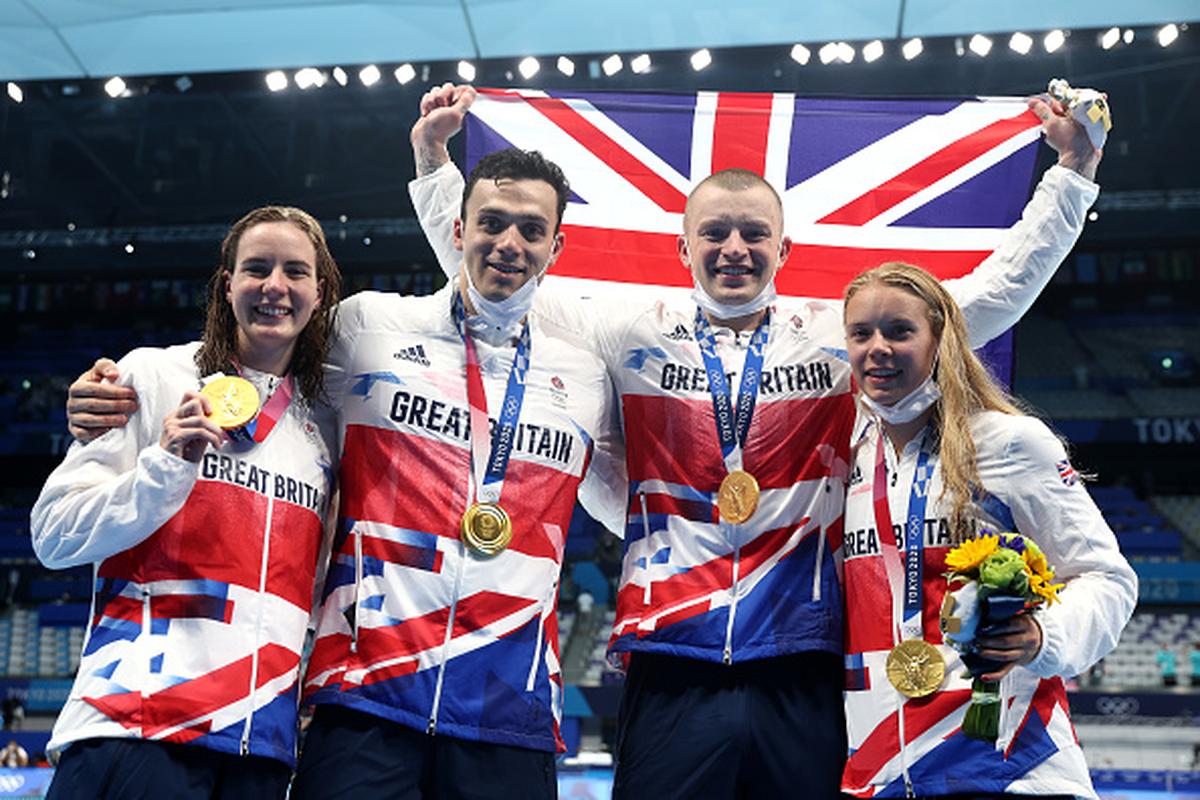 From left to right: Great Britain’s Kathleen Dawson, Adam Peaty and James Guy and Anna Hopkin poses after winning gold medal in the Mixed 4 x 100m Medley Relay at Tokyo Olympics on July 31, 2021.