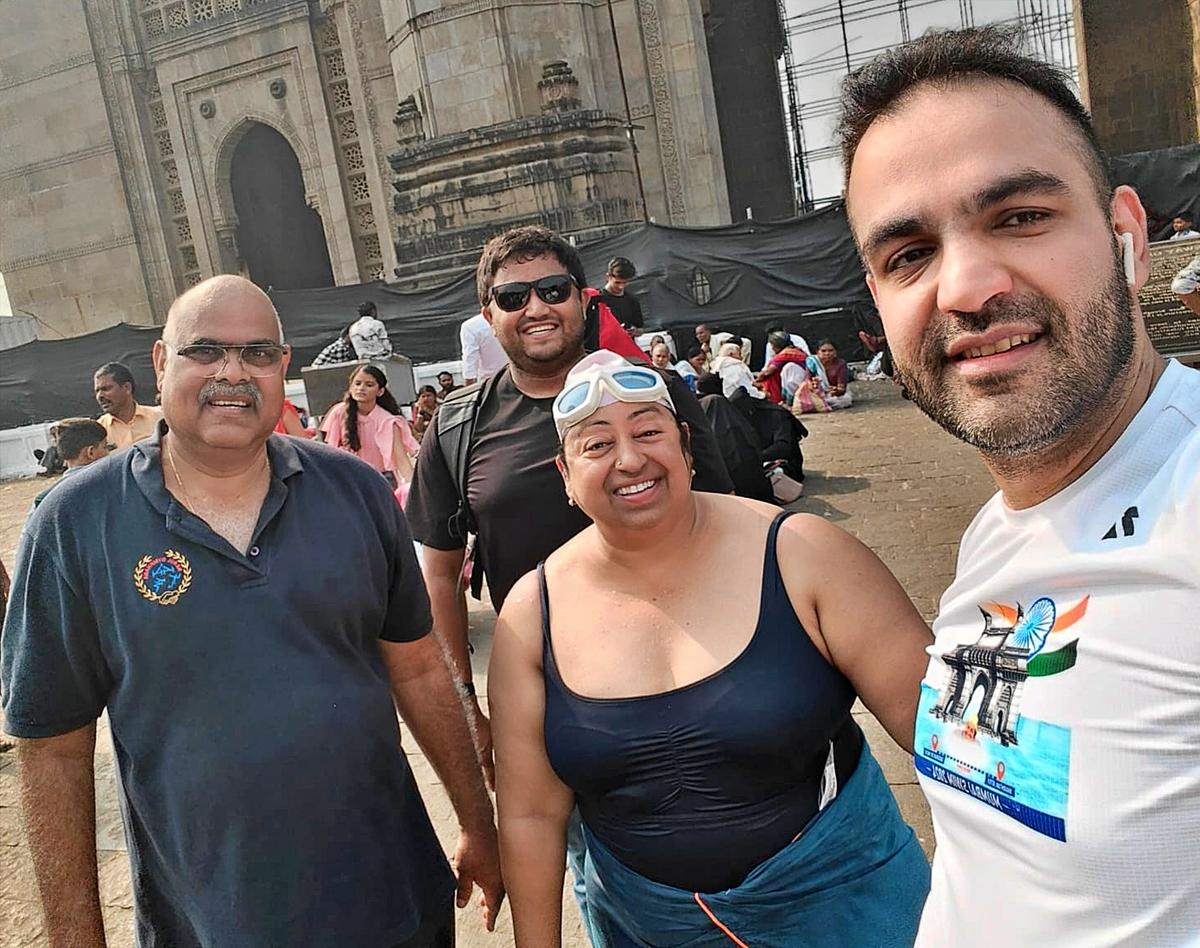 Meenakshi Pahuja (centre) with her support team after the successful
swim to the Gateway of India in Mumbai on Friday.