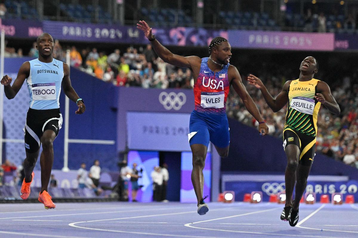 Winner US’ Noah Lyles (C) crosses the finish line ahead of Botswana’s Letsile Tebogo (L) and Jamaica’s Oblique Seville (R) in the men’s 100m final of the athletics event at the Paris 2024 Olympic Games at Stade de France.