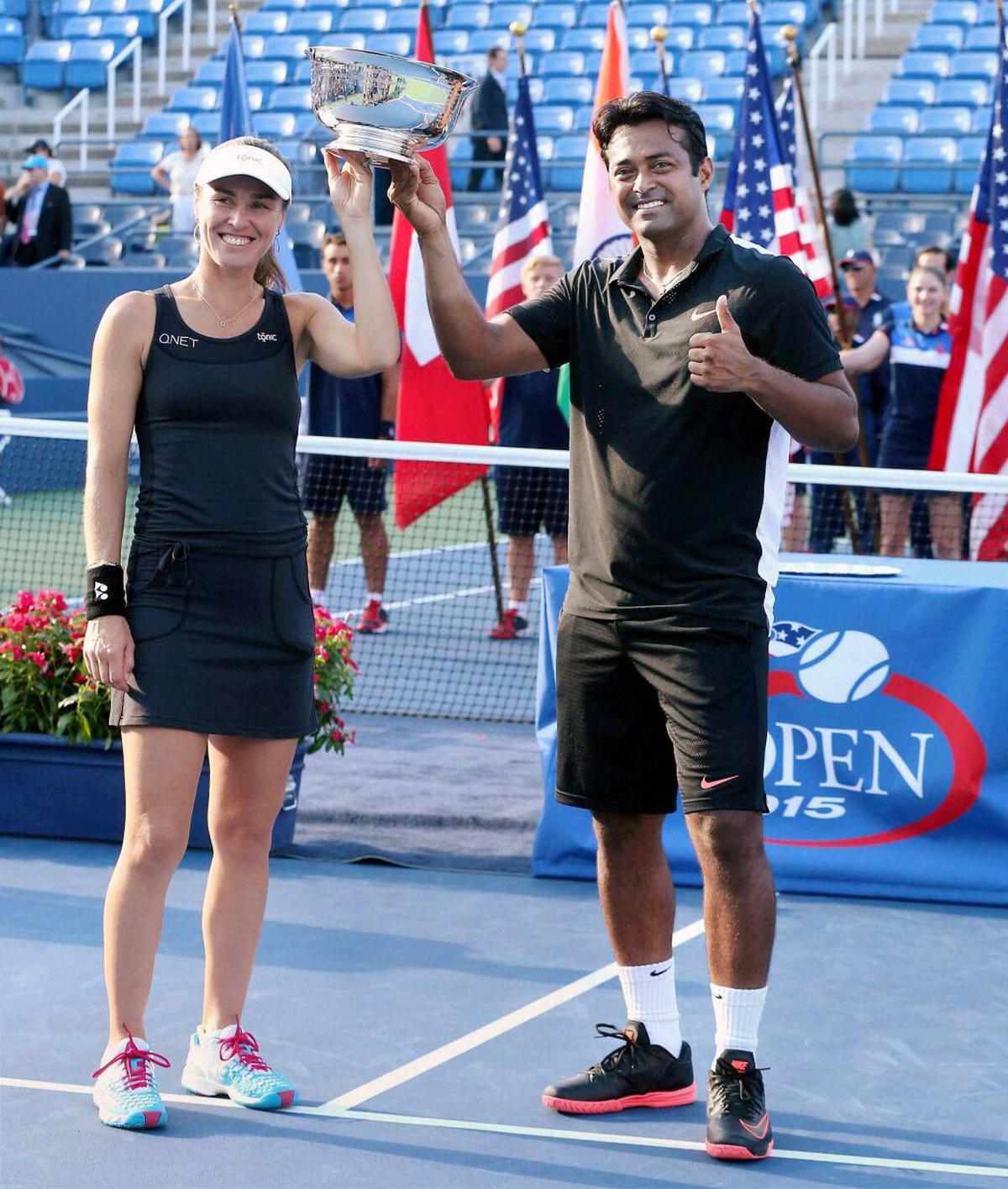 Leander Paes and Martina Hingis pose with the trophy after winning the mixed doubles final match against B Mattek-Sands and Sam Querrey at US Open in New York