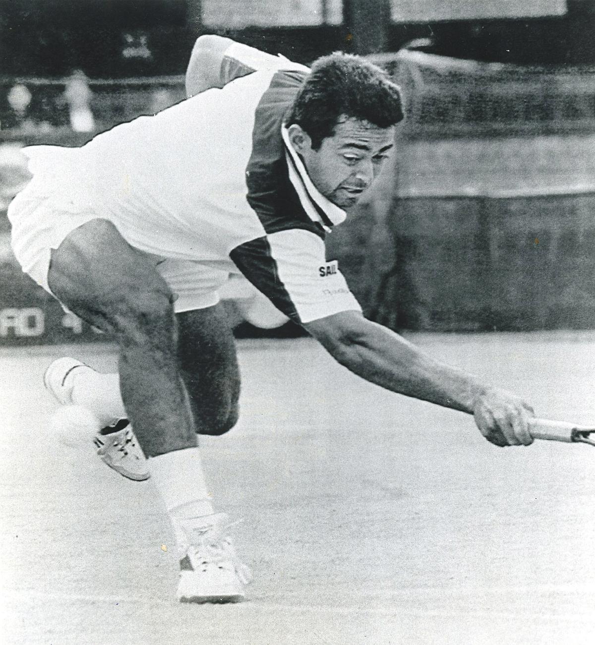 Leander Paes, bends low for a backhand return to opponent Byron Black, of Zimbabwe, during their quarter-final match at the hall of  fame Tennis Championships in New Port   on July  13, 1996.