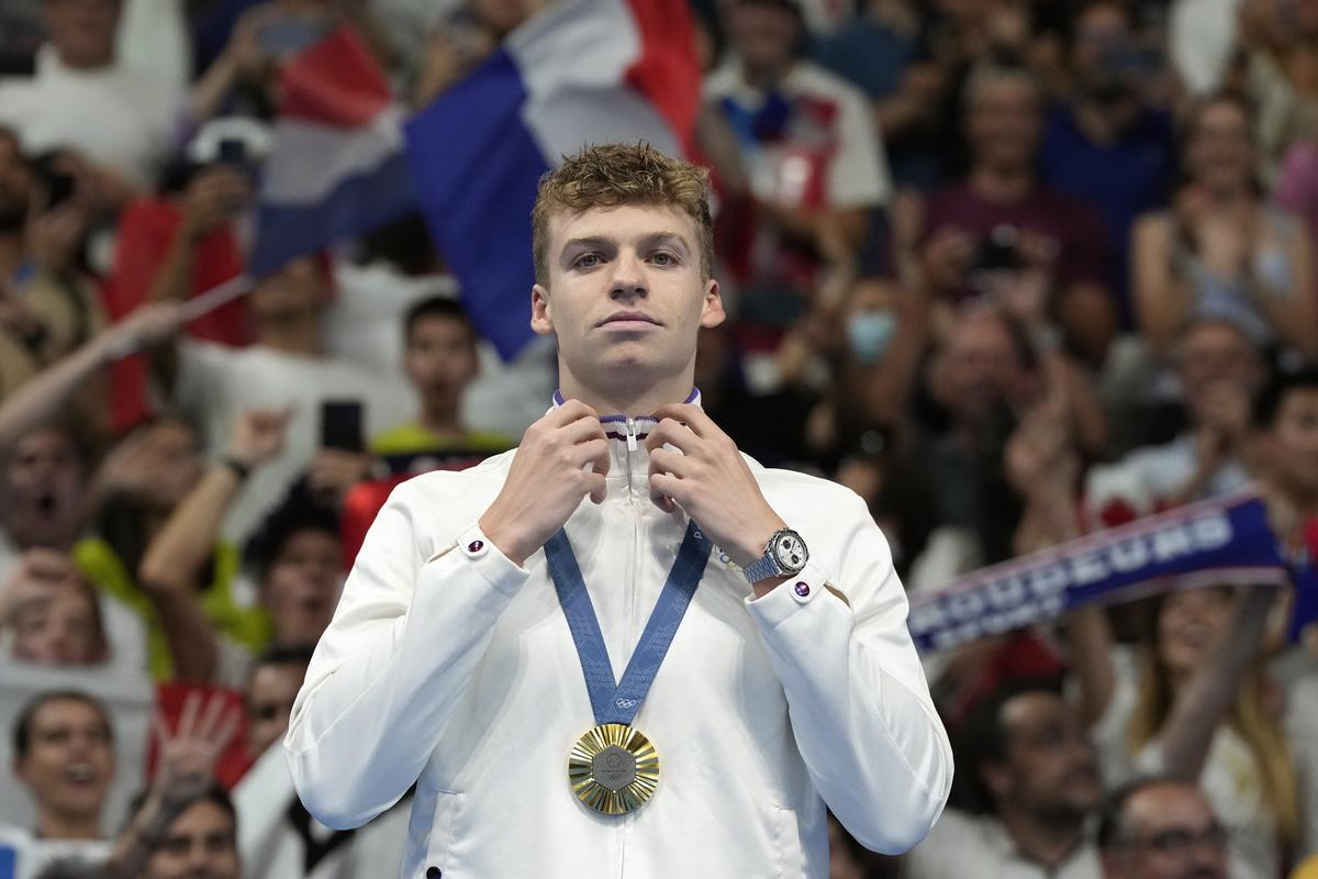 Leon Marchand of France, reacts after receiving his gold medal for the men’s 200-meter individual medley.