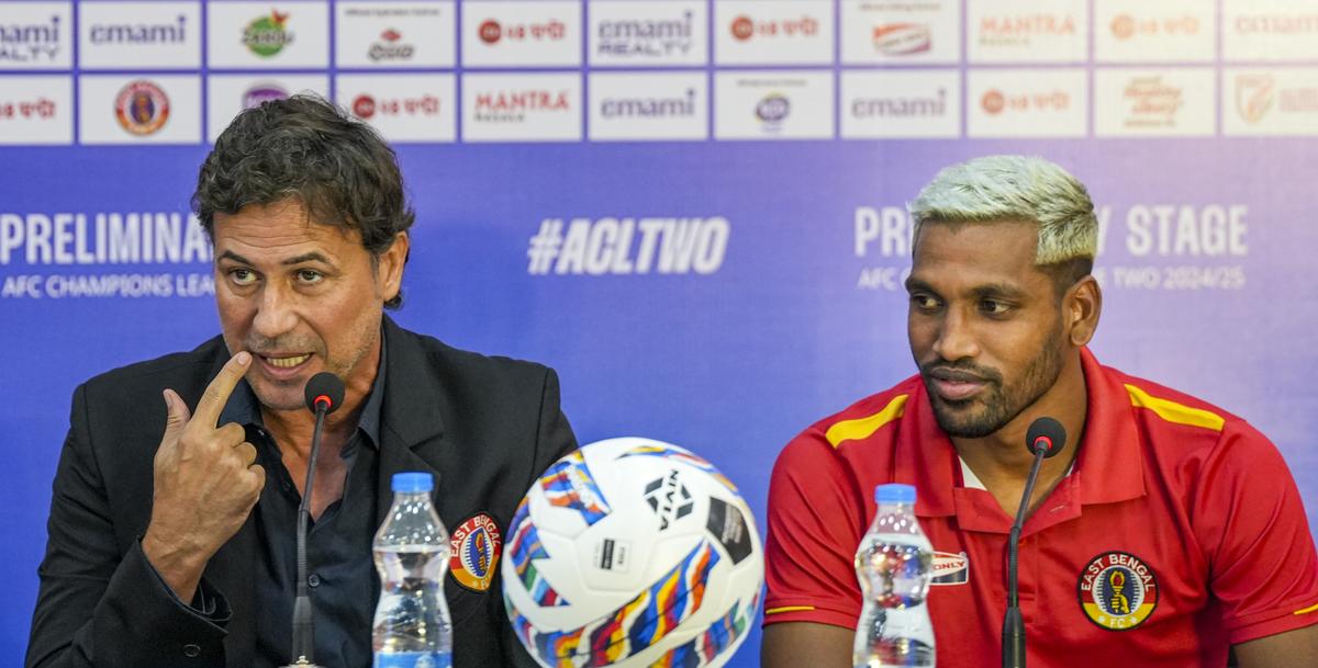 East Bengal FC head coach Carles Cuadrat (L) and player Nandhakumar Sekar interact with the media on the eve of their AFC Champions League 2 preliminary stage playoff match.