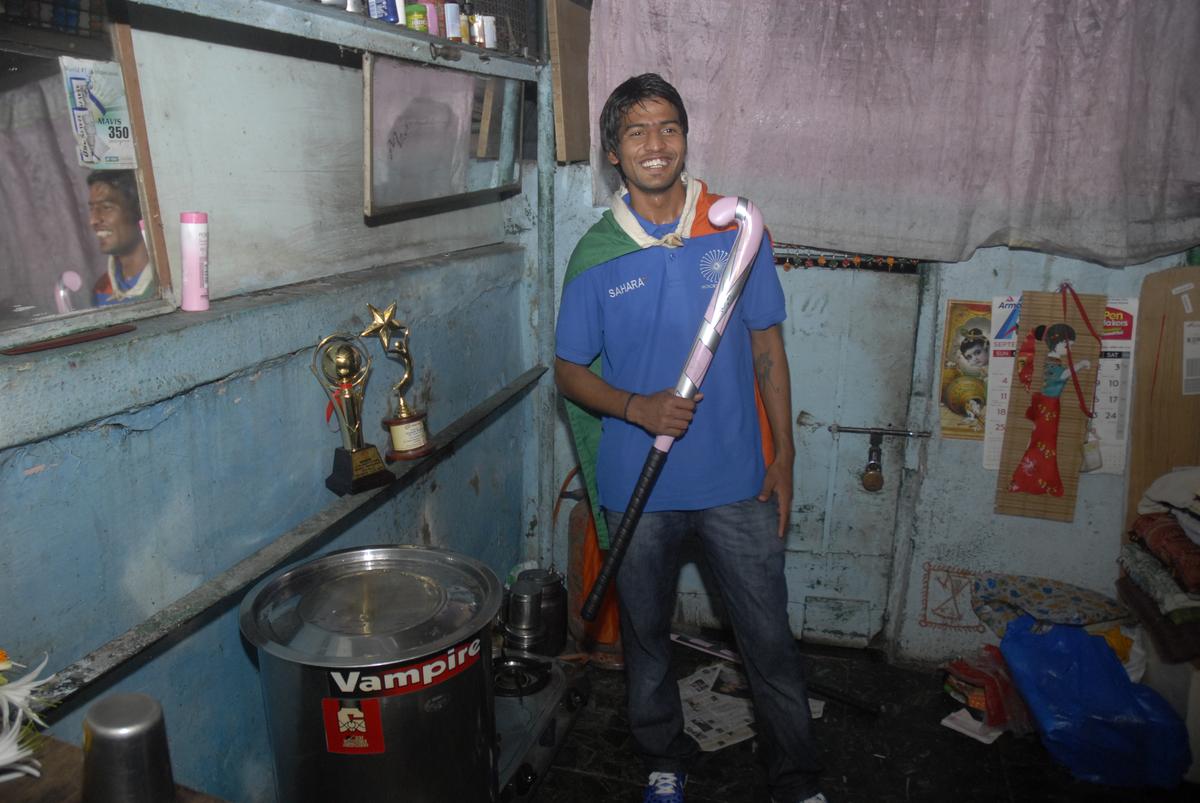 FILE PHOTO: India men’s hockey forward, Yuvraj Walmiki, inside his shanty in Marine Lines, Mumbai on September 14, 2011. 