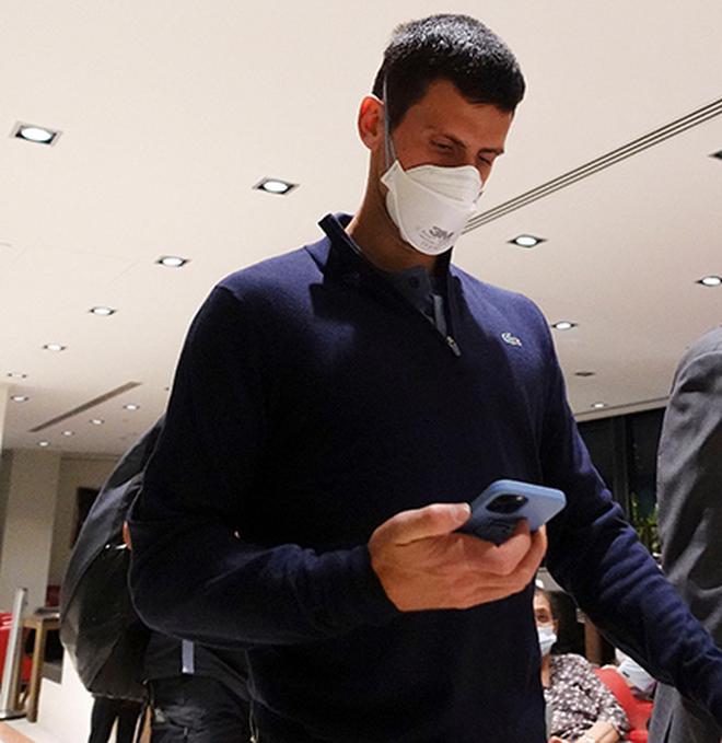 Serbian tennis player Novak Djokovic walks in Melbourne Airport before boarding a flight, after the Federal Court upheld a government decision to cancel his visa to play in the Australian Open.
