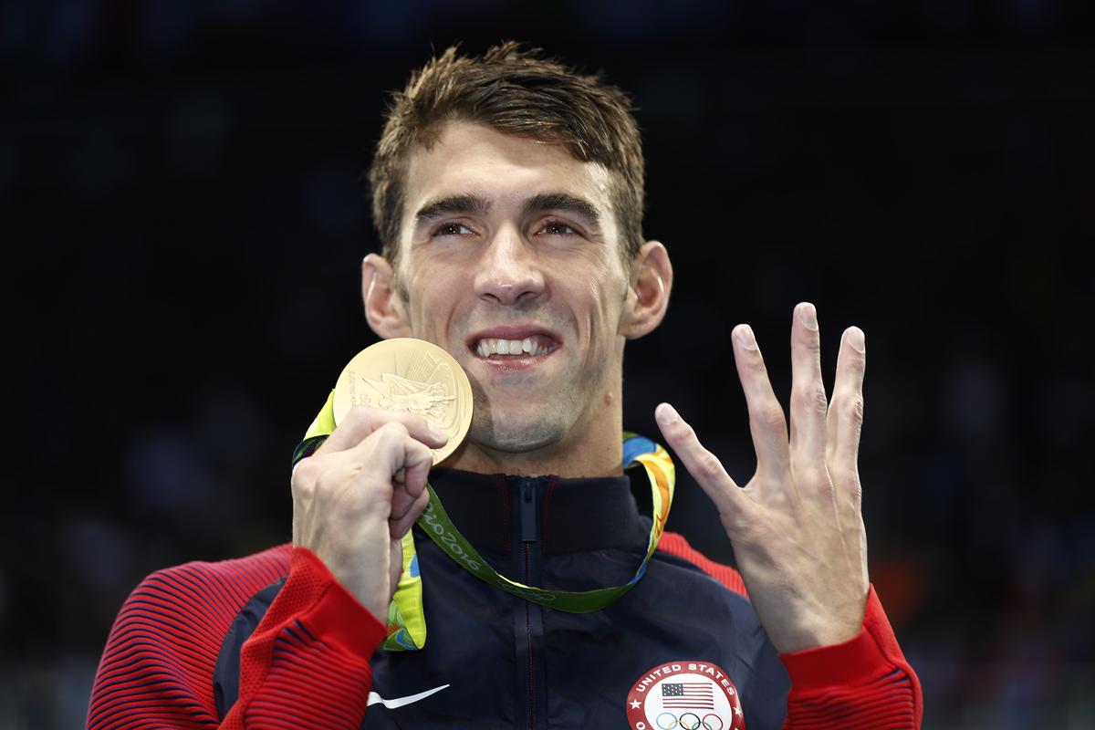 Michael Phelps of USA poses with his gold medal during the medal ceremony for the Men’s 200m Individual Medley Final at the 2016 Rio Olympics.