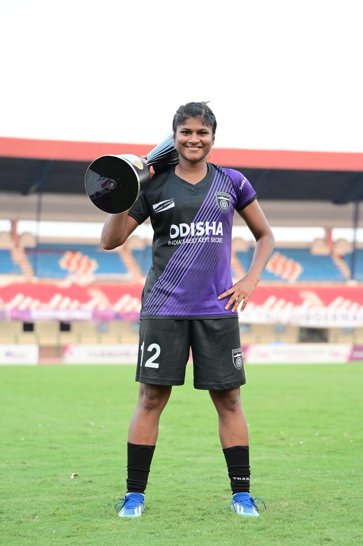 All smiles: A jubilant Indumathi Kathiresan poses with the IWL trophy. 