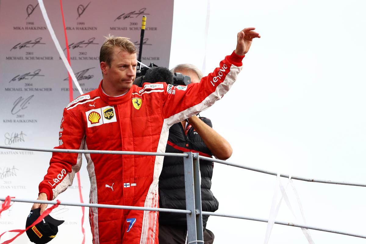 FILE PHOTO:  Kimi Raikkonen of Finland and Ferrari celebrates on the podium.