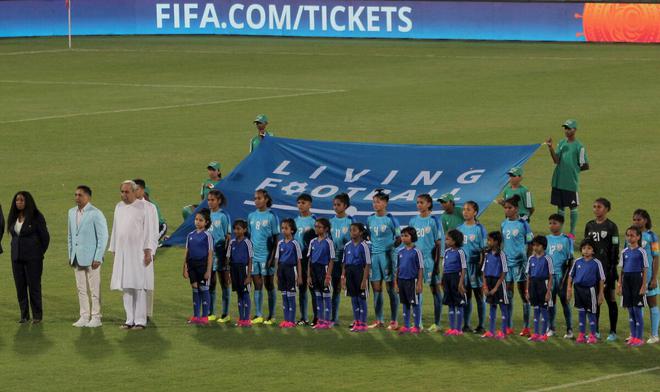 FILE PHOTO: India U-17 Women’s Football Team standing alongside Odisha Chief Minister Naveen Patnaik during the national anthem at the Kalinga stadium ahead of a FIFA Under-17 women’s World Cup match on October 11, 2022.