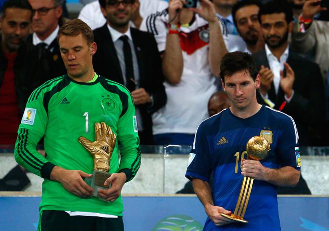 Lionel Messi (right) holds the Golden Ball trophy after the 2014 FIFA World Cup final against Germany. 