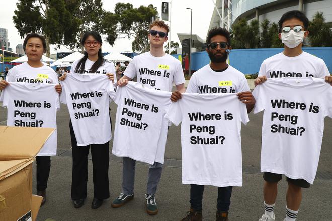 FILE PHOTO: Supporters of Chinese tennis player Peng Shuai hold up T-shirts ahead of the women’s final at the Australian Open in Melbourne on Jan. 29, 2022. 