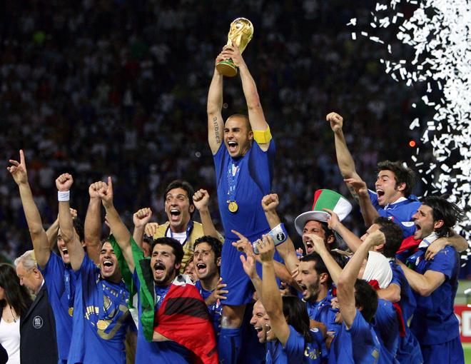 Italian defender Fabio Cannavaro (C) celebrates with the trophy after the World Cup 2006 final. 