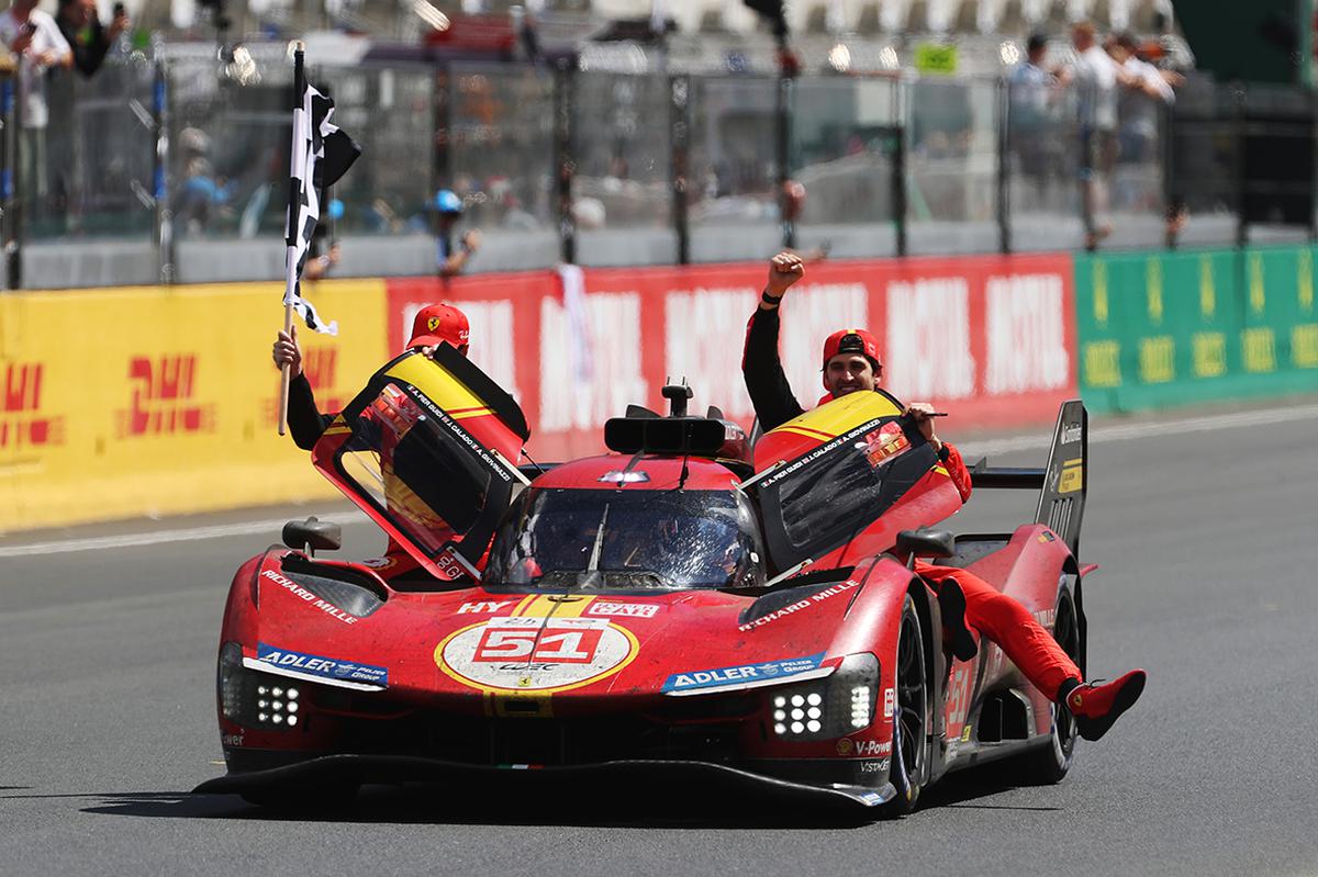 Winning trio: The race winning Ferrari AF Corse Ferrari 499P of  Alessandro Pier Guidi (driving), James Calado (L) and Antonio Giovinazzi (R) celebrate at the finish of the 100th anniversary 24 Hours of Le Mans race at the Circuit de la Sarthe June 11, 2023 in Le Mans, France.