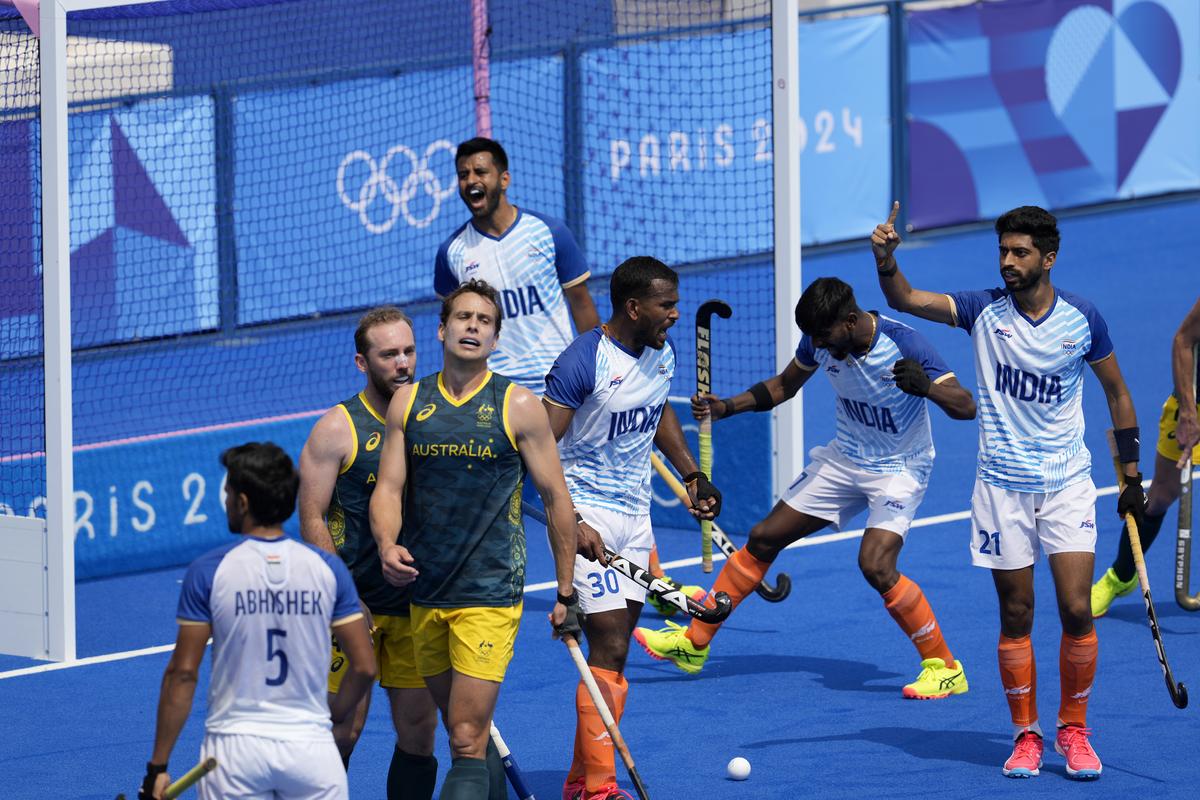 Australia’s Thomas Craig, third left, and teammate Jake Harvie, second left, react after losing to India at the end of the men’s field hockey match at the 2024 Summer Olympics.