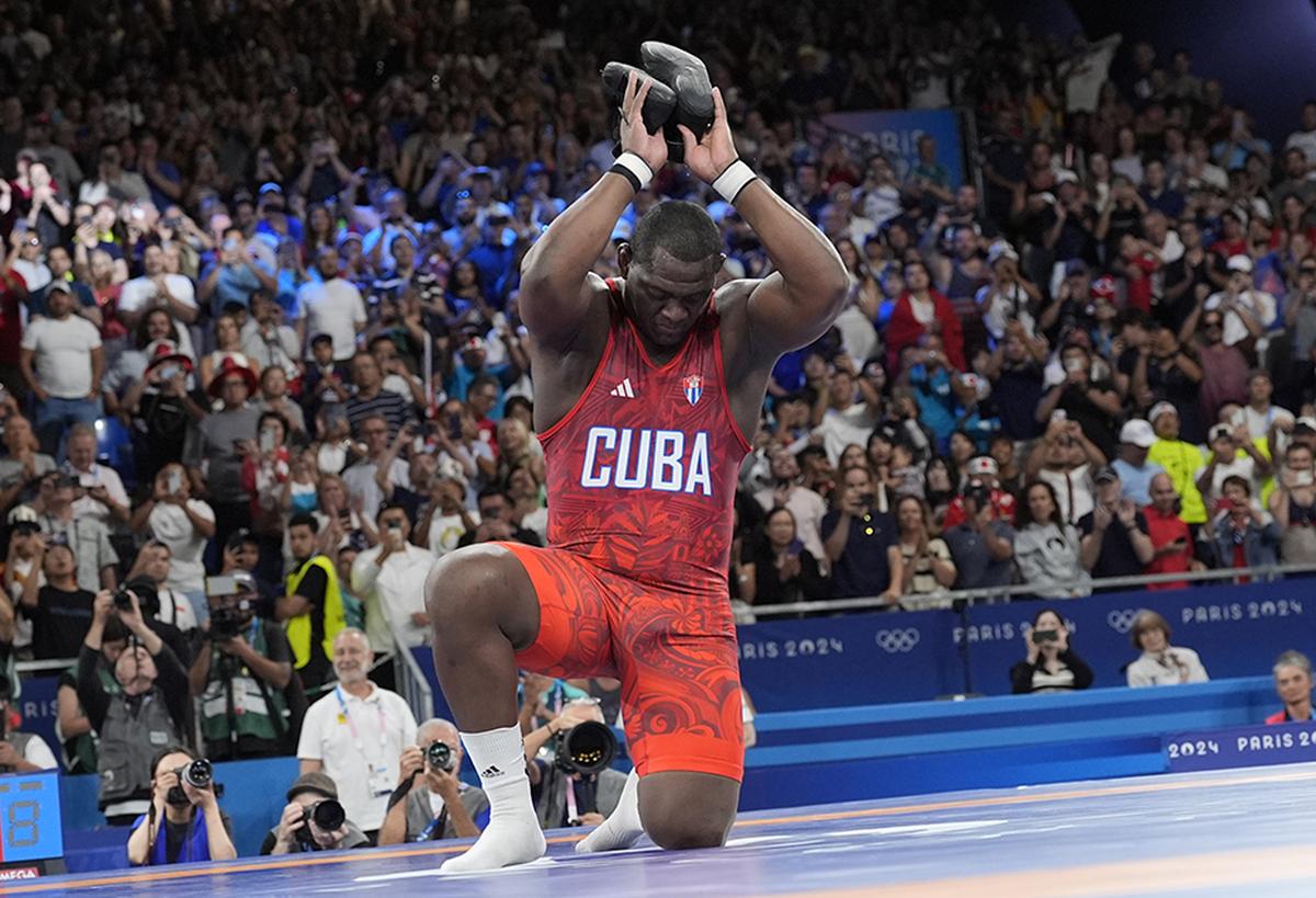 Cuba’s Mijain Lopez Nunez removes his shoes, symbolising his retirment.