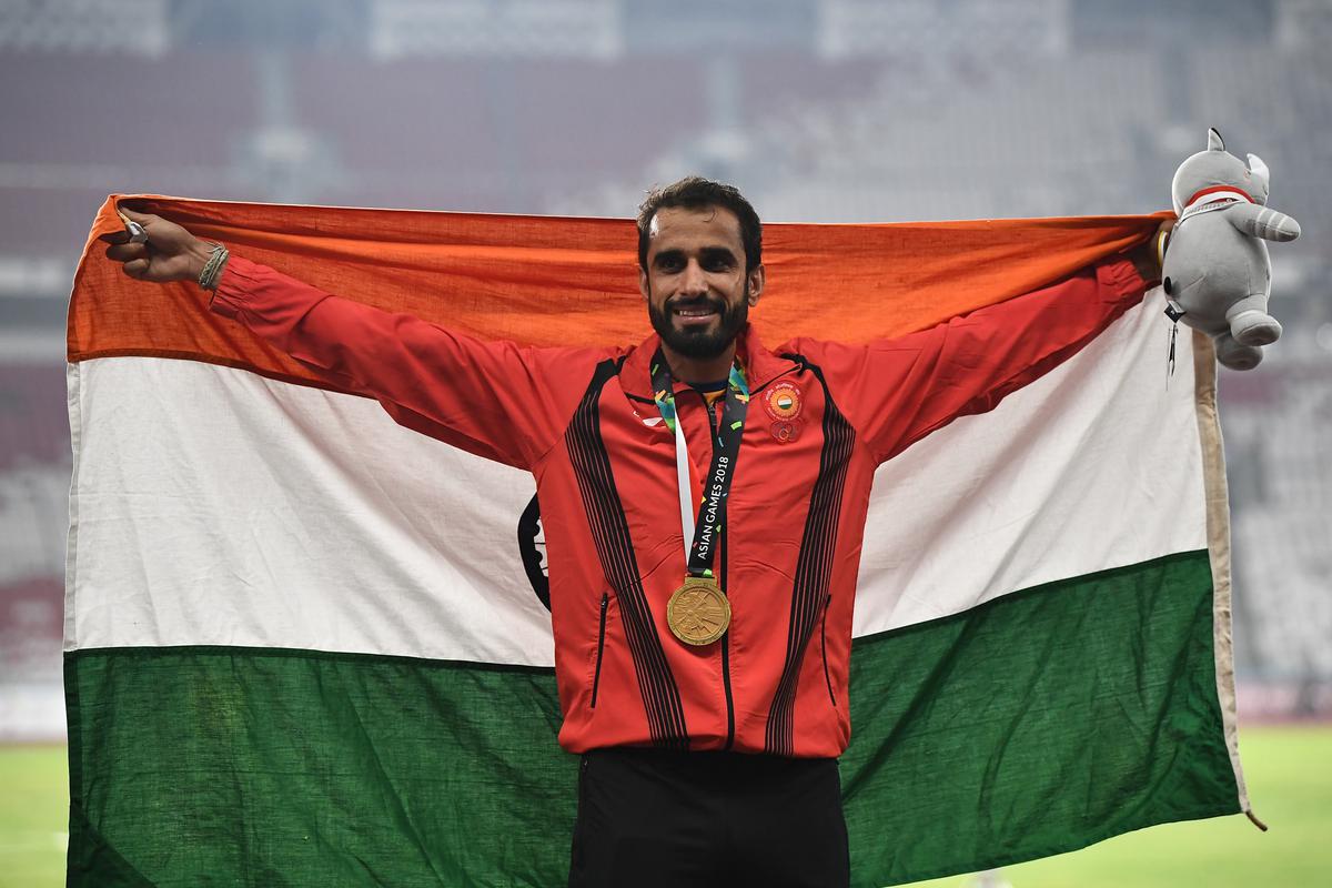 Gold medallist Manjit Singh of India celebrates on the podium during men’s 800m medal ceremony at the Asian Games 2018.