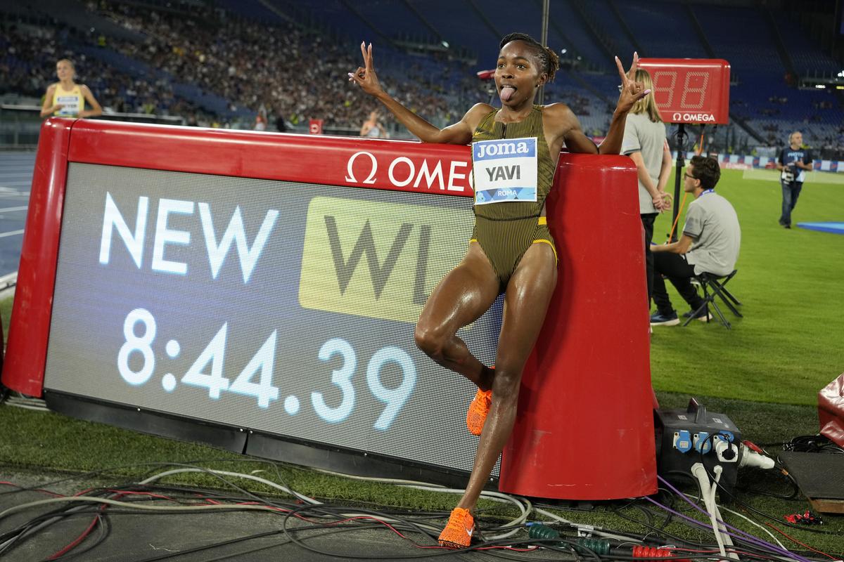 Winfred Yavi, of Bahrain, poses by the clock after setting the best mark of the season in the women’s 3000-meter steeplechase during the Diamond League Golden Gala Pietro Mennea athletics meet at the Stadio Olimpico in Rome.