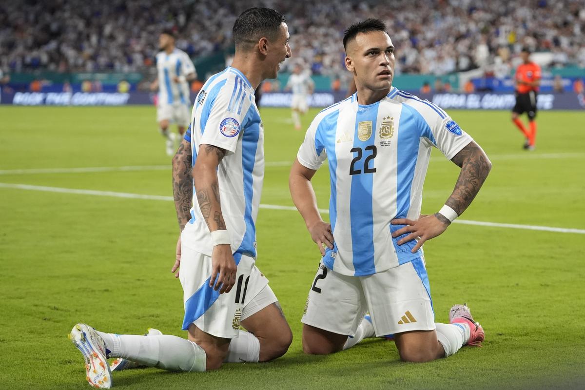 Argentina’s Lautaro MartÃ­nez (22) celebrates scoring his side’s opening goal against Peru with teammate Angel Di Maria. 