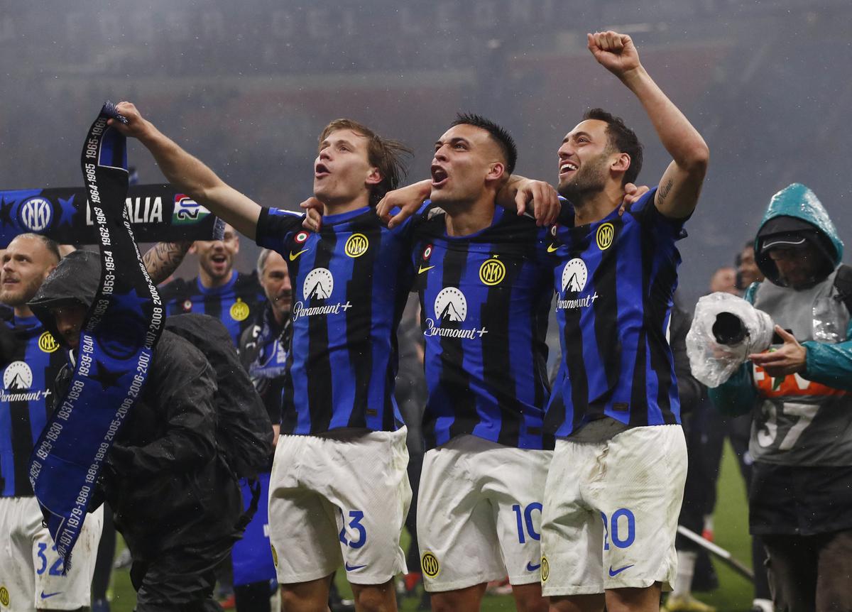 Inter Milan’s Nicolo Barella, Lautaro Martinez and Hakan Calhanoglu celebrate winning Serie A. 