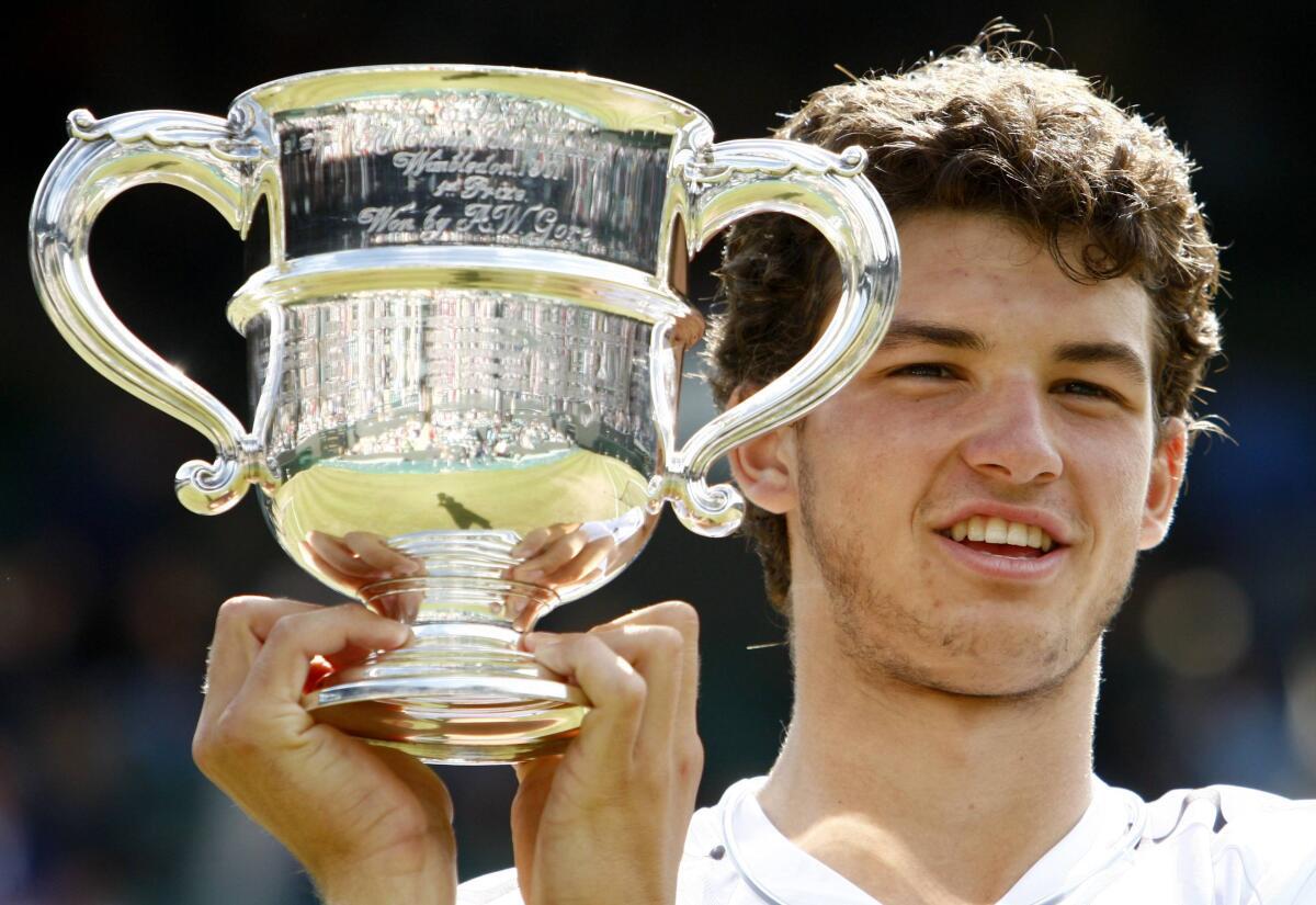 Grigor Dimitrov holds his trophy after defeating Henri Kontinen of Finland in their boys singles finals match at the Wimbledon tennis championships in London July 6, 2008. 