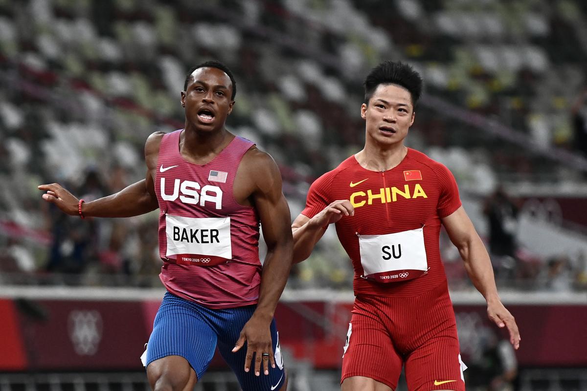 USA’s Ronnie Baker (L) and China’s Su Bingtian react after competing in  the men’s 100m final during the Tokyo 2020 Olympic Games at the Olympic Stadium in Tokyo on August 1, 2021.