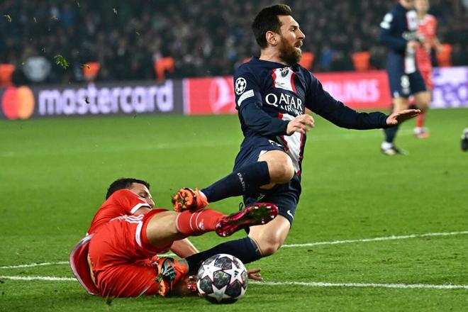 Bayern Munich defender Benjamin Pavard tackles PSG striker Lionel Messi during the UEFA Champions League match at the Parc des Princes in Paris, on February 14, 2023. 