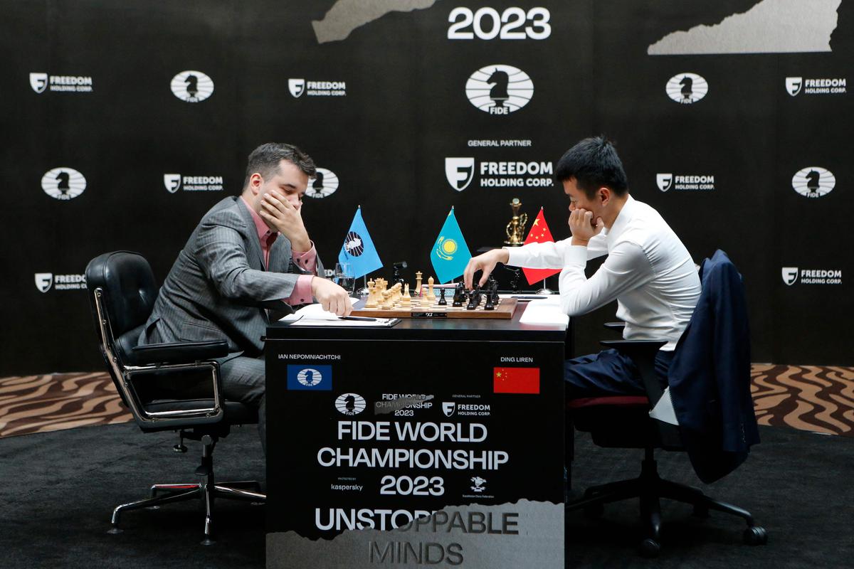 China's Ding Liren, left, and Russia's Ian Nepomniachtchi shake hands prior  to their FIDE World Chess Championship in Astana, Kazakhstan, Saturday,  April 29, 2023. Ian Nepomniachtchi and Ding Liren are facing off