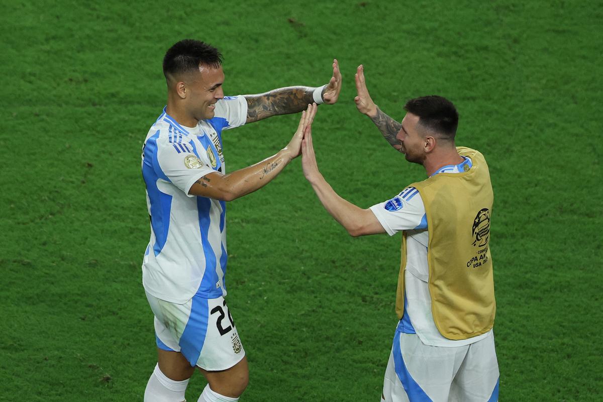 Lautaro Martinez of Argentina celebrates with Lionel Messi of Argentina after scoring the team’s first goal during the CONMEBOL Copa America 2024 final.