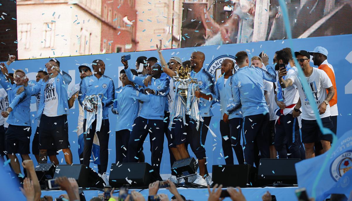 Vincent Kompany of Manchester City lifts the Premier League Trophy during the Manchester City Trophy Parade in Manchester city centre on May 14, 2018 in Manchester, England.
