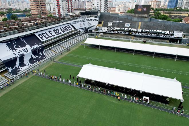 Flags remembering Pelé are displayed on the stands as mourners queue inside Vila Belmiro stadium to pay their respects to Pelé.