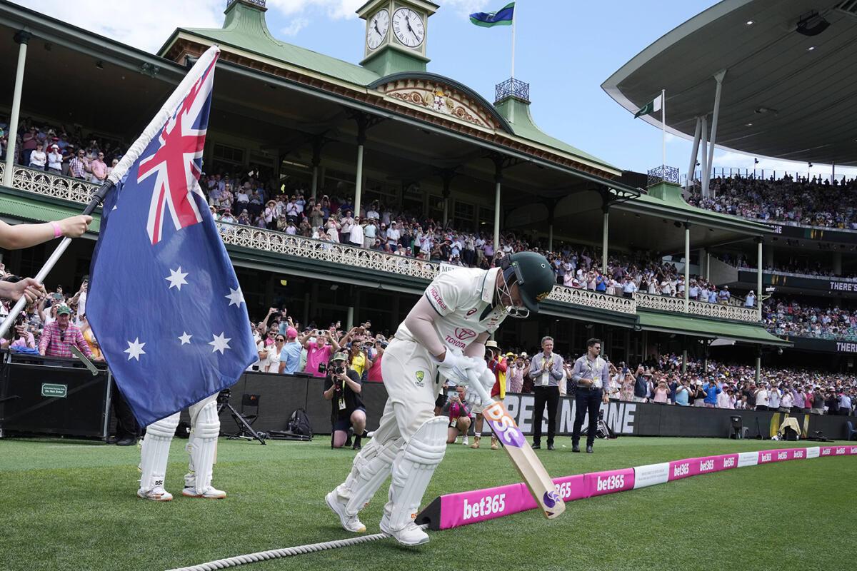 Australia’s David Warner takes to the field to bat in his final Test.