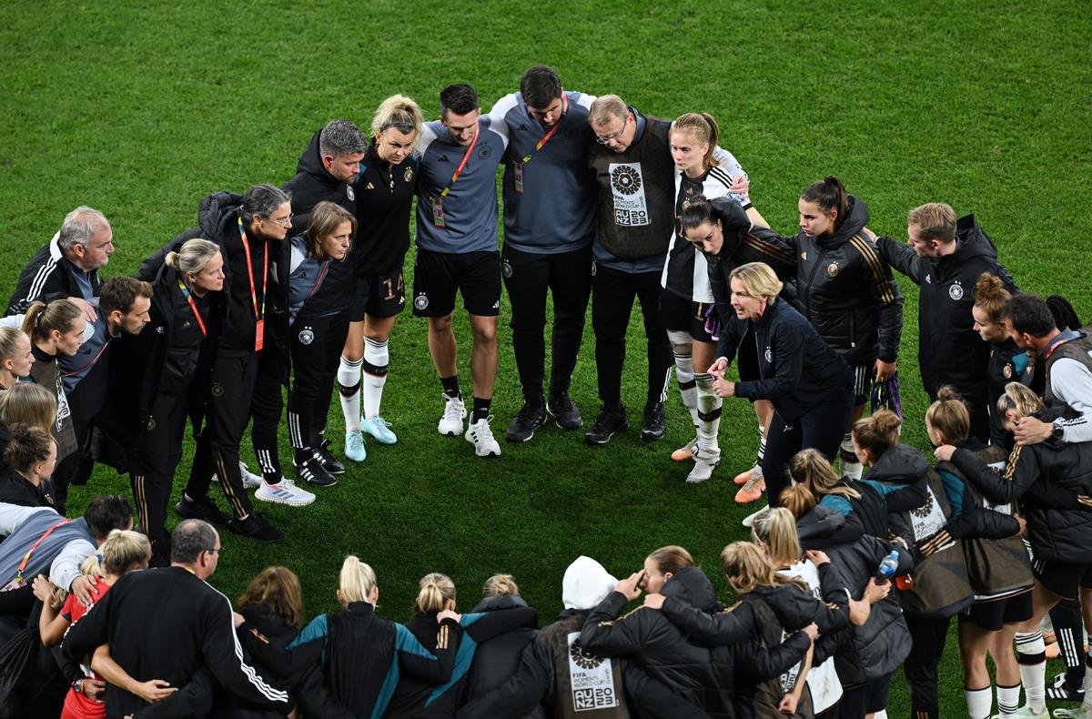 A rallying cry: Germany coach Martina Voss-Tecklenburg speaks with players after the Germany vs Colombia match.