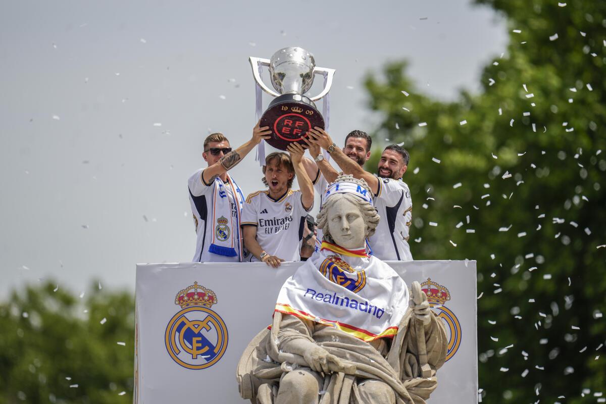 Real Madrid‘s Toni Kroos, Luka Modric, Nacho and Dani Carvajal celebrate as they hold the Spanish La Liga trophy