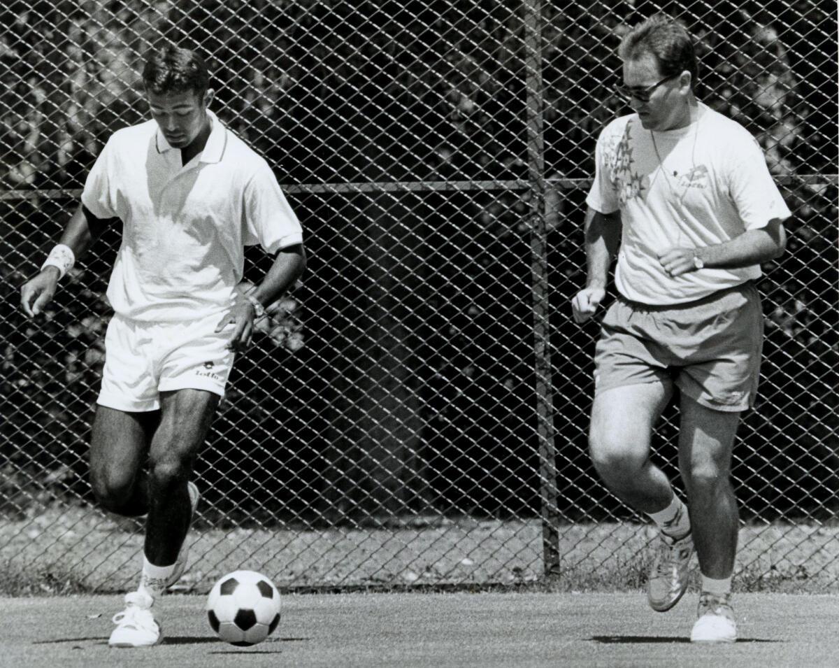 ndian Davis Cup tennis team member Leander Paes and coach Enrico Pipemo take time off to play football after the practice session at the Gymkhana courts, New Delhi on March 22, 1994.
