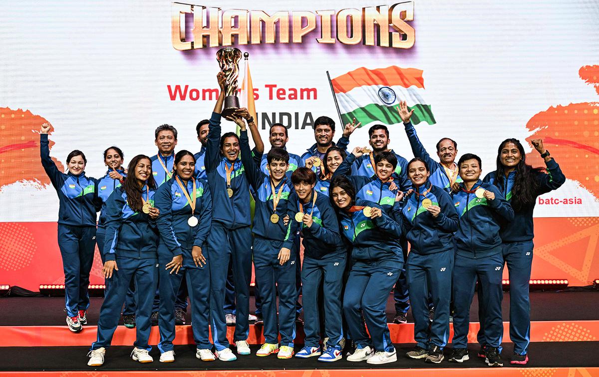 India’s women players celebrate with the trophy after winning against Thailand at the Badminton Asia Team Championships.