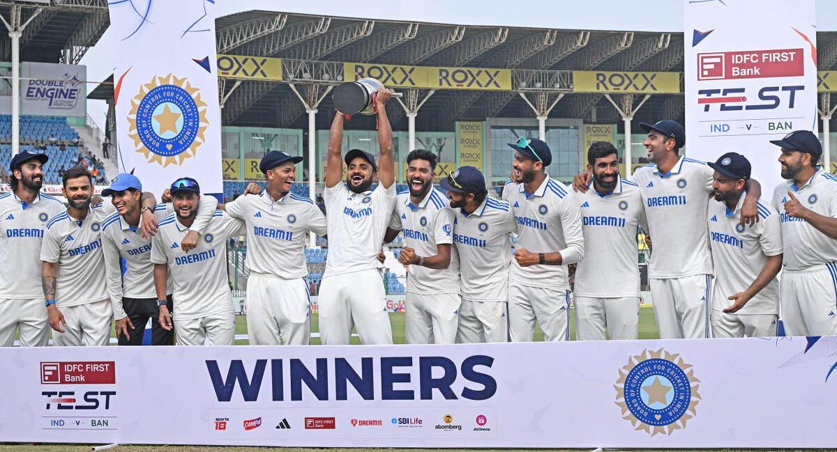 The Indian team with the trophy after winning the two-Test series against Bangladesh. 