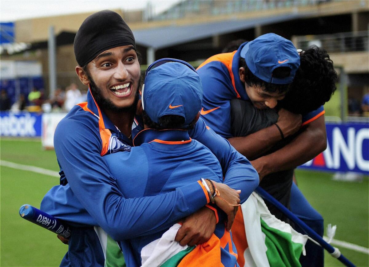 Harmeet Singh (left) celebrates with his teammates after India defeated Australia in the U-19 Cricket World Cup final in Townsville. 