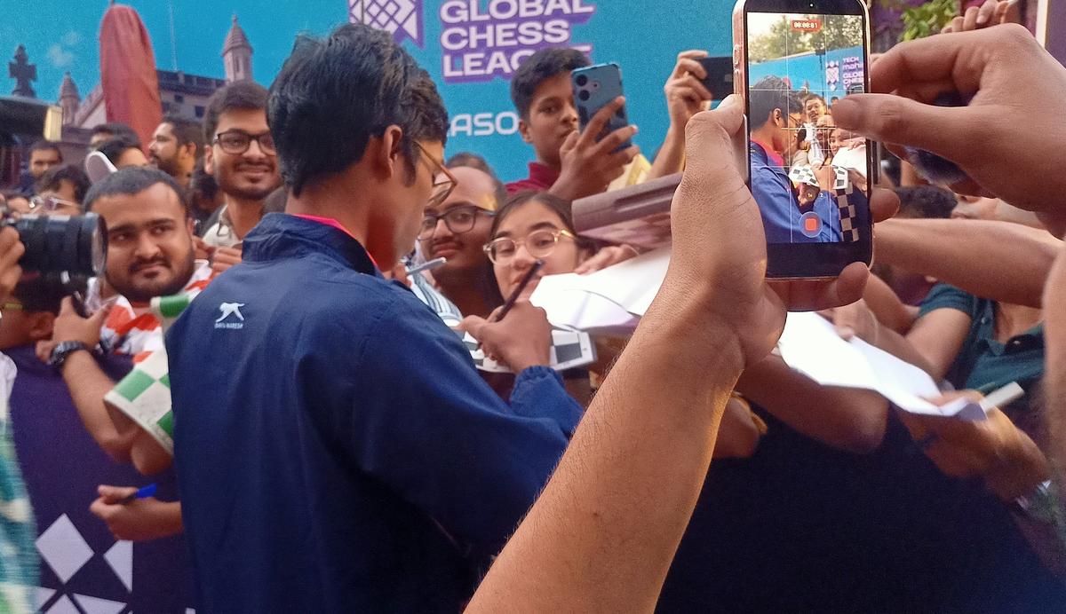 R. Praggnanandhaa signing autographs at the Global Chess League in Mumbai. 