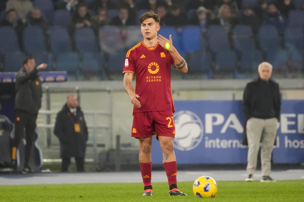 A laser beam shines on Roma’s Paulo Dybala’s hand as he prepares to take a free kick during the quarterfinal Italian Cup match between Lazio and Roma at Rome’s Olympic Stadium.